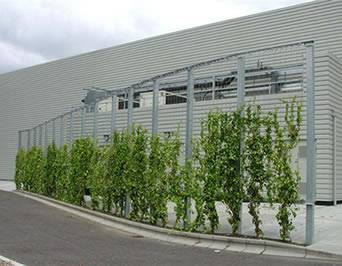 Stainless steel cable mesh are mounted to a steel frame to create a green wind-proof wall along the road.