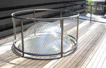 A round protective net around a ball-shaped glass lamp to protect it from damages.