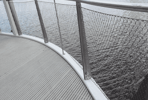 Stainless steel cable meshes are mounted to tubular frame to form balustrade panels for stairs.