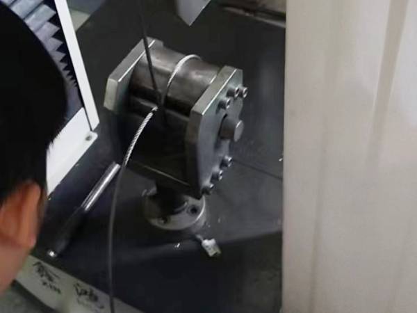 A worker detects the maximum stress of wire rope with tensile strength tester